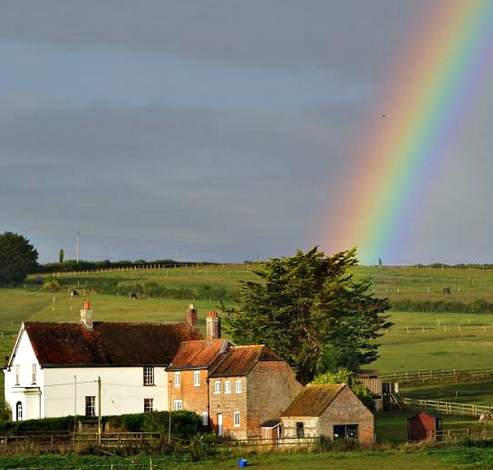 Amazing rainbow with house in the foreground